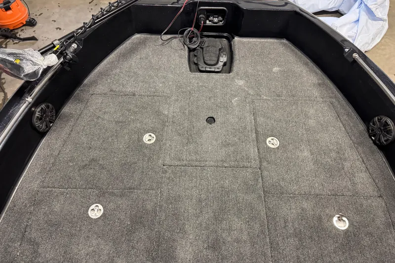 Slide: The Image of 2026 Nitro ZV19 Sport boat deck with gray carpet and storage compartments. - 17