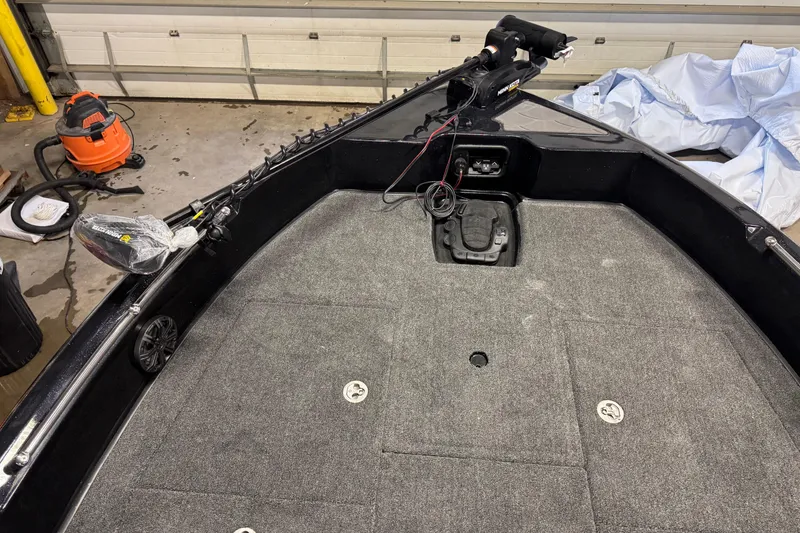 Slide: The Image of 2026 Nitro ZV19 Sport boat interior with carpeted deck and trolling motor. - 18