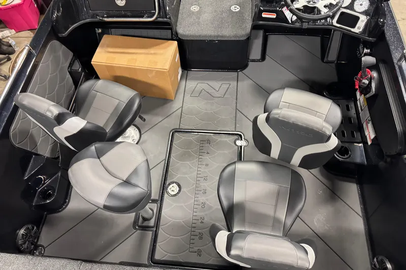 Slide: The Image of Interior of 2026 Nitro ZV19 Sport boat with four seats and a cardboard box. - 21