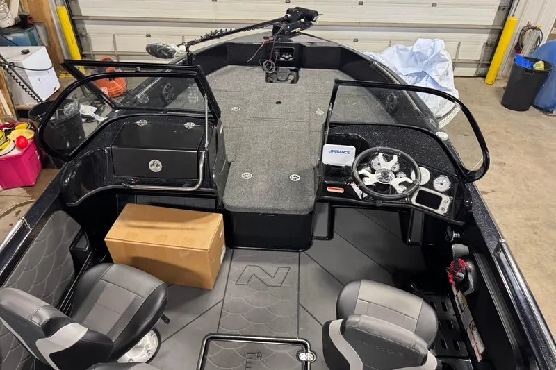 Slide: The Image of 2026 Nitro ZV19 Sport boat interior with steering wheel, seats, and dashboard in a garage. - 22