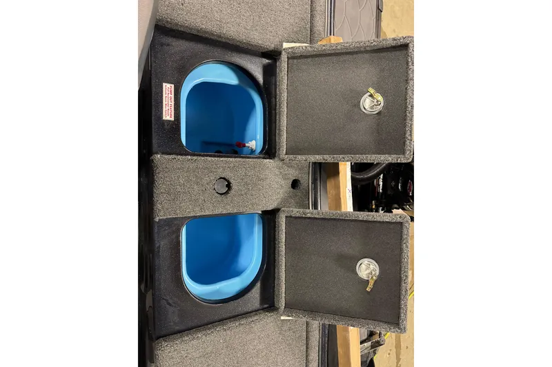 Slide: The Image of 2026 Nitro ZV19 Sport boat storage compartments with blue interior and secure latches. - 27