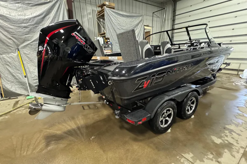 Slide: The Image of 2026 Nitro ZV19 Sport boat with powerful outboard motor in a garage setting. - 3