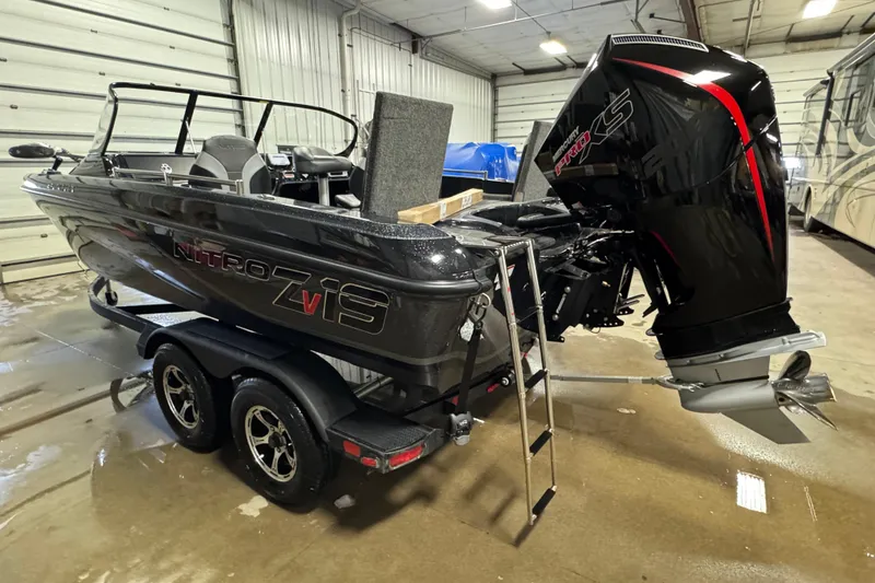 Slide: The Image of 2026 Nitro ZV19 Sport boat in a garage, featuring a powerful outboard motor. - 4