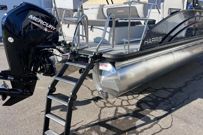 Slide: The Image of 2026 Harris 210 Cruiser SLDH pontoon boat with Mercury outboard motor and boarding ladder. - 11