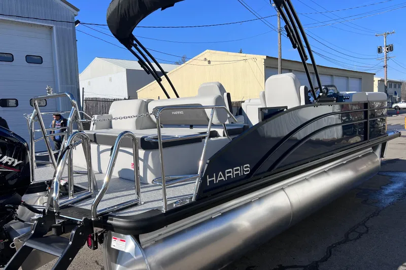 Slide: The Image of 2026 Harris 210 Cruiser SLDH pontoon boat with sleek design and modern features. - 12