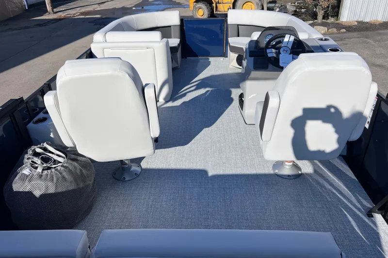 Slide: The Image of 2026 Harris 210 Cruiser SLDH interior with white seating and steering console. - 14