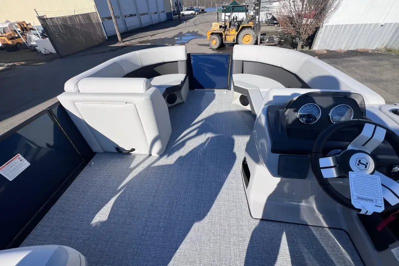 Slide: The Image of 2026 Harris 210 Cruiser SLDH pontoon boat interior with seating and steering console. - 19