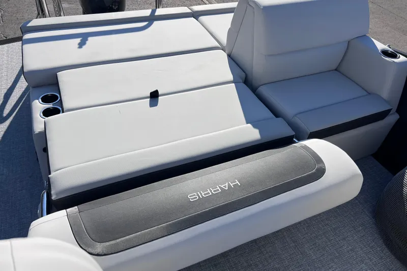 Slide: The Image of 2026 Harris 210 Cruiser SLDH boat interior with plush seating and cup holders. - 23