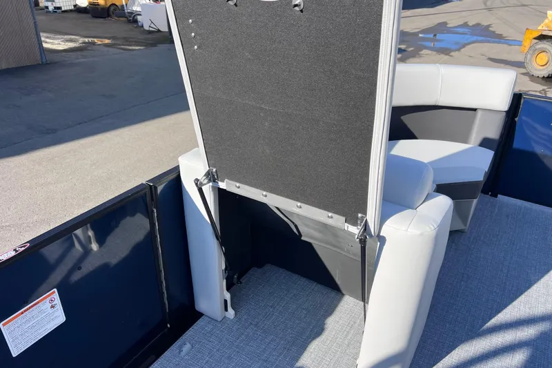 Slide: The Image of 2026 Harris 210 Cruiser SLDH boat interior with seating and storage compartment. - 27