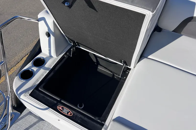 Slide: The Image of Open storage compartment on 2026 Harris 210 Cruiser SLDH boat with cup holders. - 29