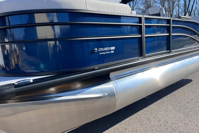 Slide: The Image of 2026 Harris 210 Cruiser SLDH pontoon boat with sleek blue exterior and modern design. - 9