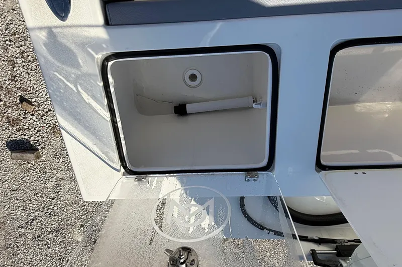 Slide: The Image of 2025 May-Craft 245 Offshore CC boat storage compartment with open lid. - 15