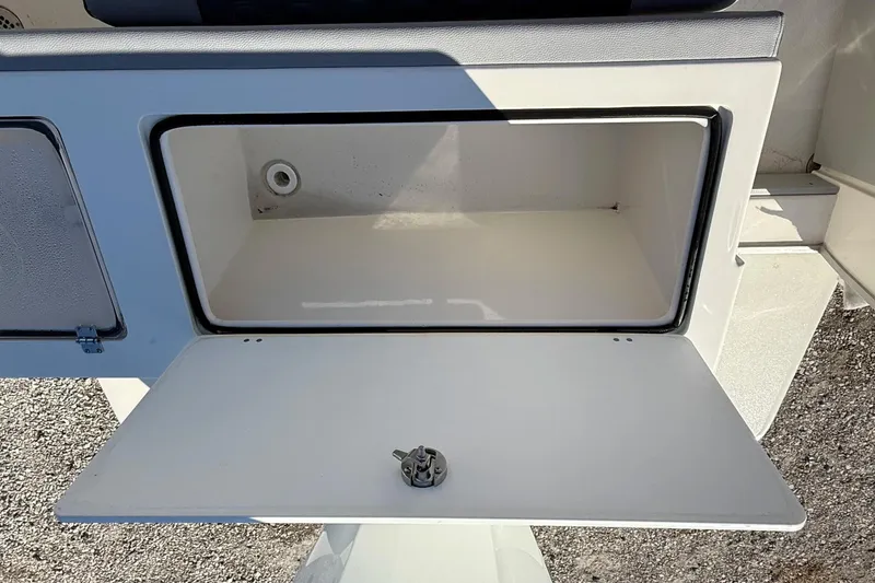 Slide: The Image of Open storage compartment on 2025 May-Craft 245 Offshore CC boat. - 16