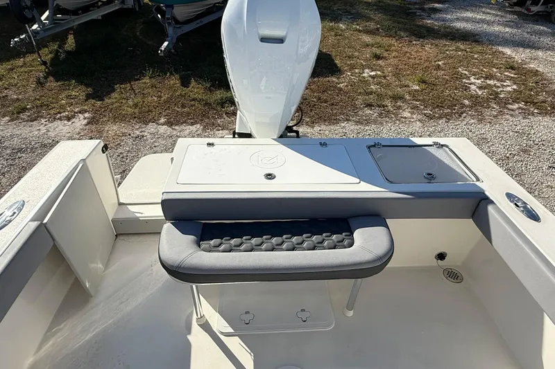 Slide: The Image of 2025 May-Craft 245 Offshore CC boat interior with cushioned seating and storage compartments. - 17