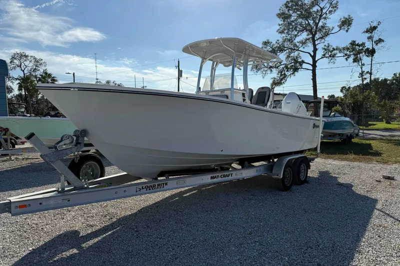 Slide: The Image of 2025 May-Craft 245 Offshore CC boat on trailer in sunny outdoor setting. - 2