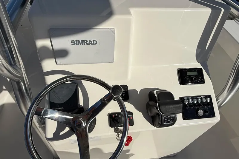 Slide: The Image of 2025 May-Craft 245 Offshore CC helm with Simrad electronics and Honda controls. - 9