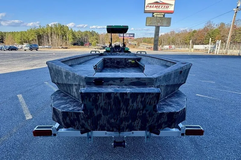 Slide: The Image of 2026 Havoc 1756 boat in parking lot, camo design, clear sky background. - 3