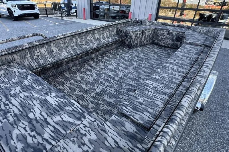 Slide: The Image of 2026 Havoc 1756 boat with camouflage interior, parked outdoors near a building. - 6