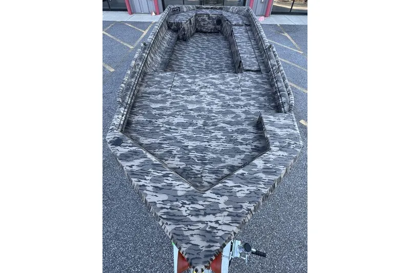 Slide: The Image of Camouflage-patterned interior of a 2026 Havoc 1756 boat, parked on asphalt. - 7