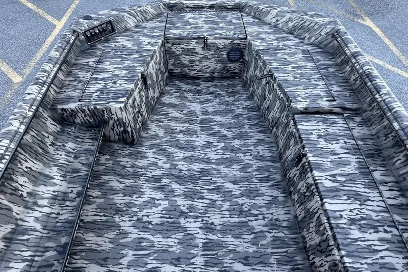 Slide: The Image of 2026 Havoc 1756 boat interior with camouflage pattern, featuring spacious seating and storage compartments. - 8