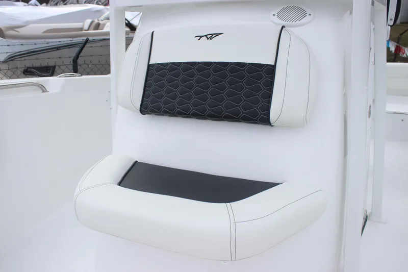 Slide: The Image of 2026 Tidewater 220 LXF boat seat with black and white cushioned design. - 10
