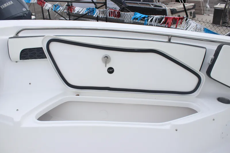 Slide: The Image of 2026 Tidewater 220 LXF boat storage compartment with sleek design and secure lock. - 11