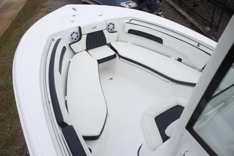 Slide: The Image of 2026 Tidewater 220 LXF boat interior with white cushioned seating and speakers. - 14