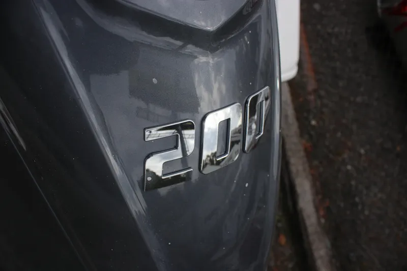 Slide: The Image of Close-up of 2026 Tidewater 220 LXF boat with "200" chrome emblem. - 21