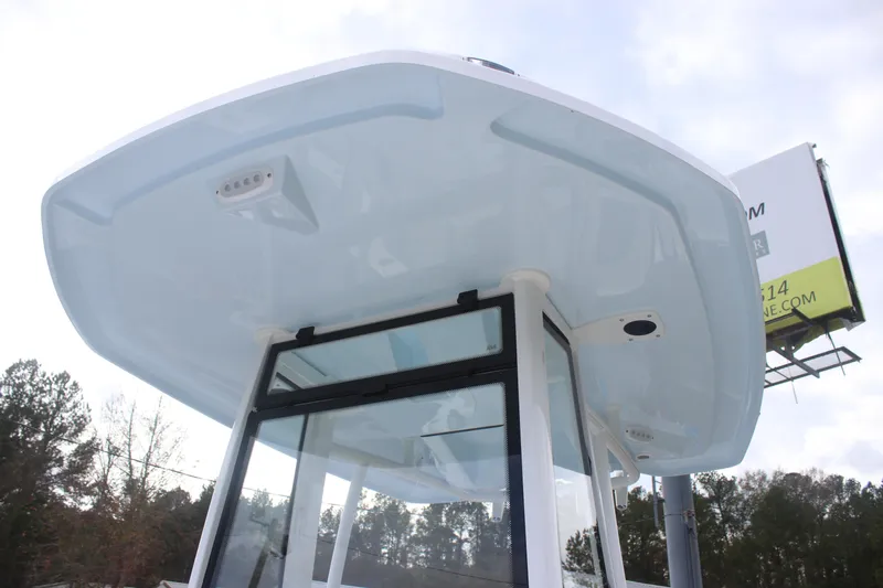 Slide: The Image of 2026 Tidewater 220 LXF boat with sleek T-top design against a cloudy sky. - 9