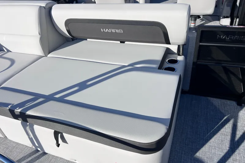 Slide: The Image of 2026 Harris Cruiser 230 SLDH Tritoon boat seating with cup holders, gray upholstery. - 10