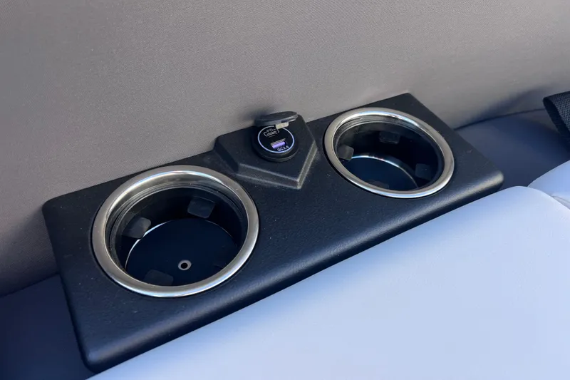 Slide: The Image of Cup holders and USB port in 2026 Harris Cruiser 230 SLDH Tritoon boat interior. - 15