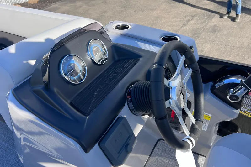 Slide: The Image of 2026 Harris Cruiser 230 SLDH Tritoon dashboard with steering wheel and gauges. - 17