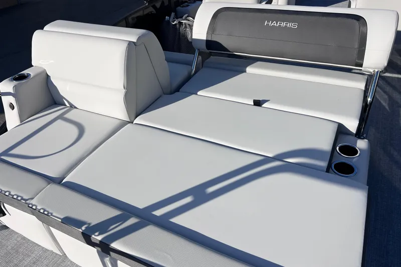 Slide: The Image of 2026 Harris Cruiser 230 SLDH Tritoon with luxurious white seating and cup holders. - 24