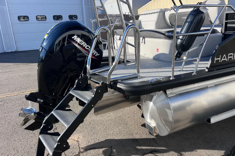 Slide: The Image of 2026 Harris Cruiser 230 SLDH Tritoon with Mercury outboard motor and boarding ladder. - 7