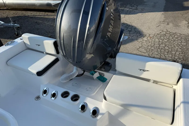 Slide: The Image of 2026 Tidewater 198 CC Adventure boat interior with Yamaha engine, featuring white seating and cup holders. - 3