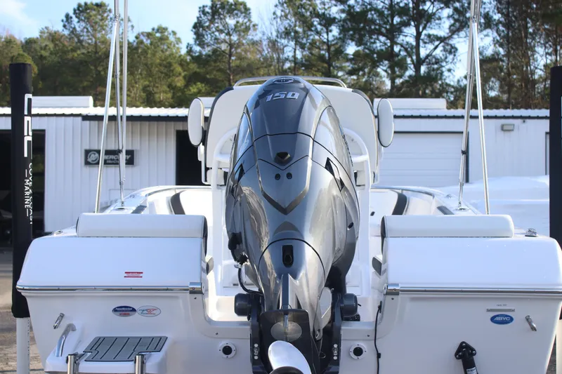 Slide: The Image of 2026 Tidewater 198 CC Adventure boat with powerful outboard motor, docked outdoors. - 8