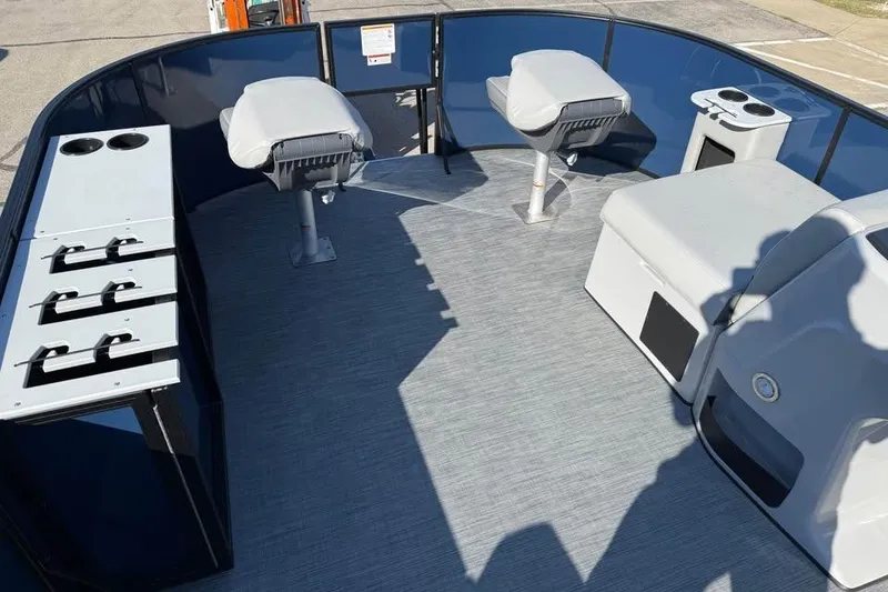 Slide: The Image of 2025 Lowe LF 194 boat interior with seating, storage, and cup holders. - 10