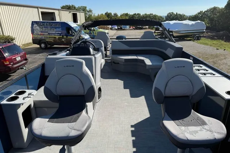 Slide: The Image of 2025 Lowe LF 194 pontoon boat interior with seating and cup holders. - 11