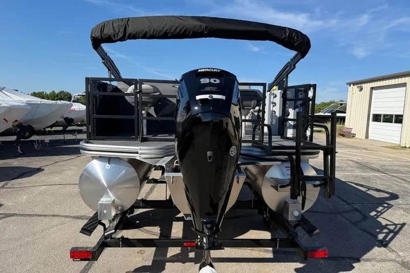Slide: The Image of 2025 Lowe LF 194 pontoon boat with Mercury 90 engine, parked outdoors. - 5