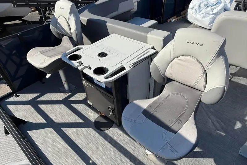 Slide: The Image of 2025 Lowe LF 194 boat interior with two cushioned seats and a central console. - 6