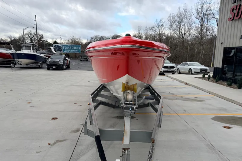 Slide: The Image of 2011 Sunsation F4 boat on trailer, parked outdoors near other vehicles. - 11