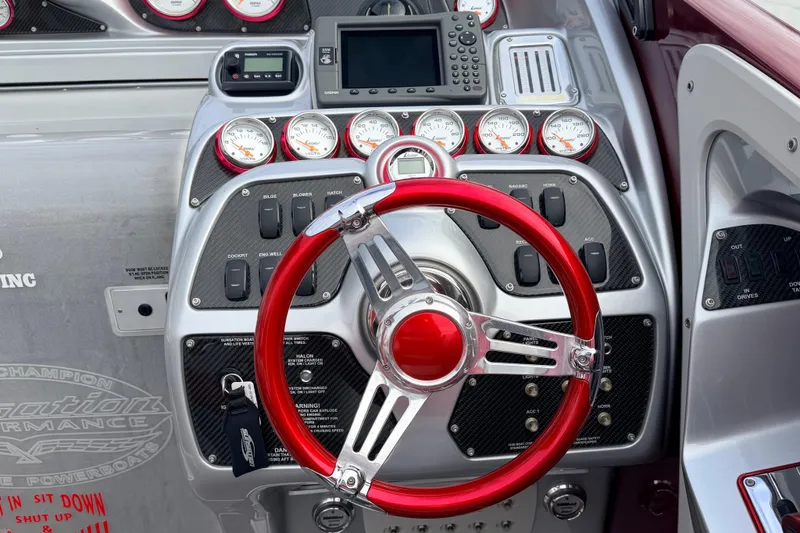 Slide: The Image of 2011 Sunsation F4 dashboard with red steering wheel and multiple gauges. - 12