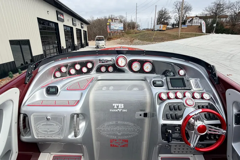 Slide: The Image of 2011 Sunsation F4 boat dashboard with gauges, controls, and red steering wheel. - 13