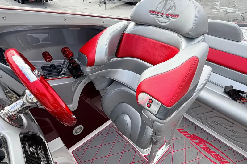 Slide: The Image of Interior of a 2011 Sunsation F4 boat with red and gray seating and controls. - 14