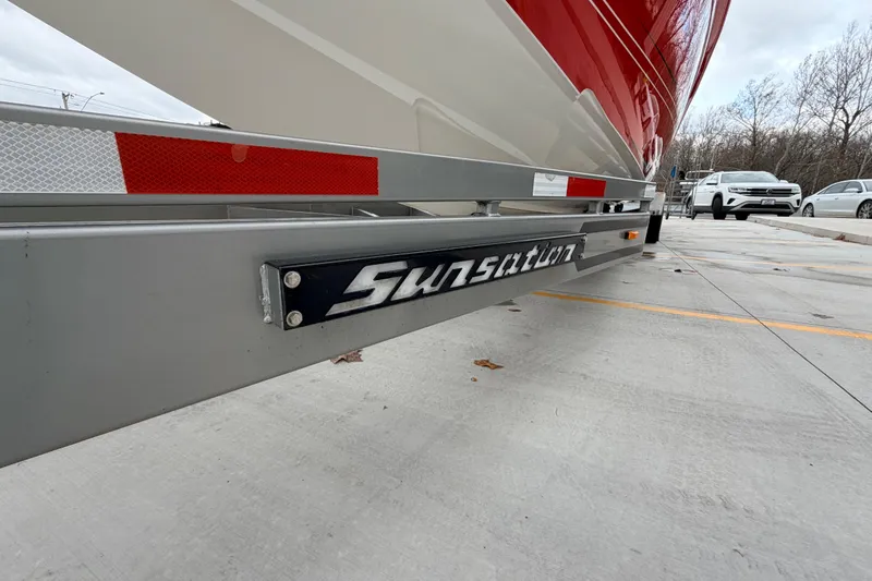 Slide: The Image of 2011 Sunsation F4 boat on trailer, close-up view of branding and red accents. - 27