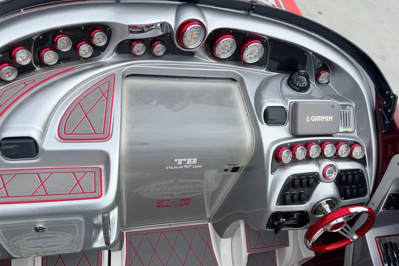 Slide: The Image of 2011 Sunsation F4 boat dashboard with gauges, Garmin device, and red accents. - 34