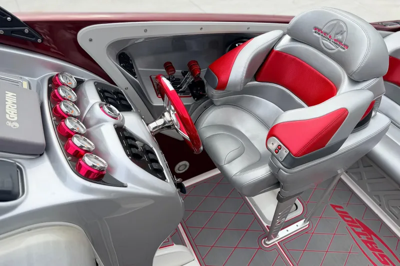 Slide: The Image of 2011 Sunsation F4 boat interior with red and gray seating, steering wheel, and control panel. - 35