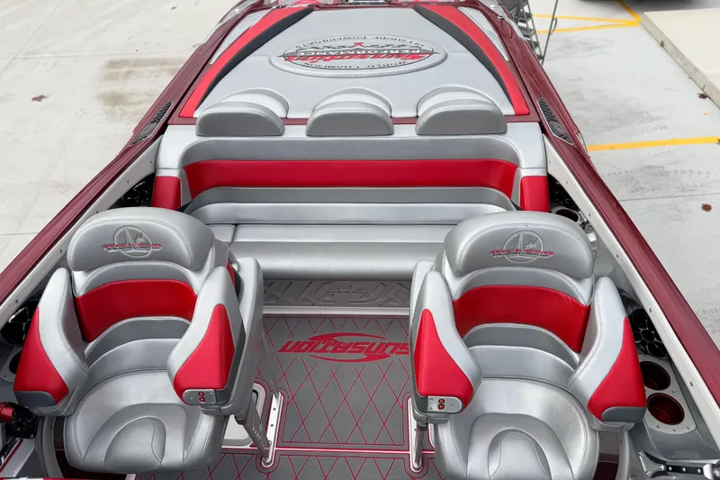 Slide: The Image of 2011 Sunsation F4 boat interior with red and gray seating and logo detailing. - 36