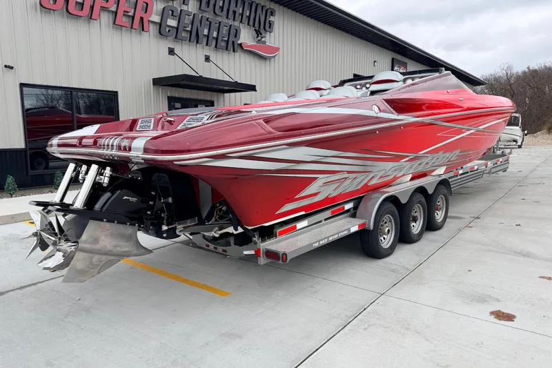 Slide: The Image of 2011 Sunsation F4 powerboat in red on a trailer outside a boating center. - 4