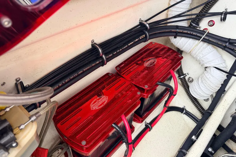 Slide: The Image of 2011 Sunsation F4 engine compartment with red battery covers and organized wiring. - 42